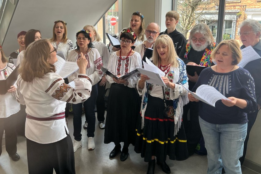 A group of people singing as a choir