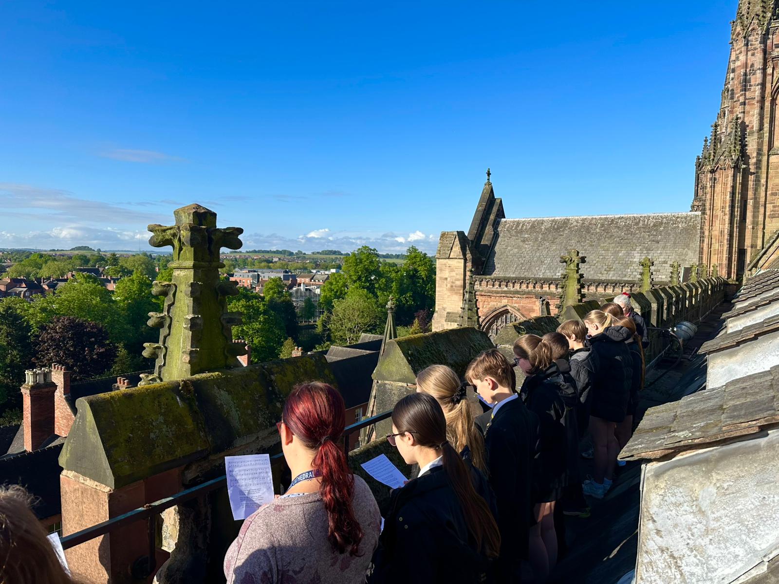 Choristers singing from the roof of the Cathedral