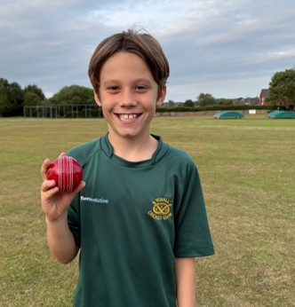 Joshua after cricket match holding the ball