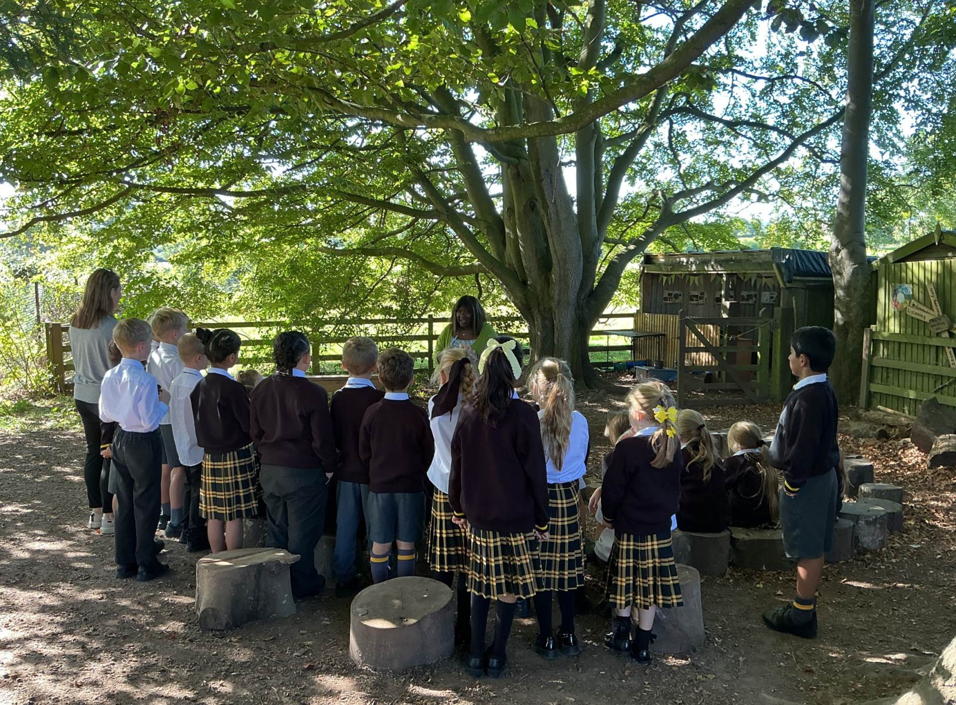 Sensory walk for Year 3 pupils A group of primary children gathered around a fire pit